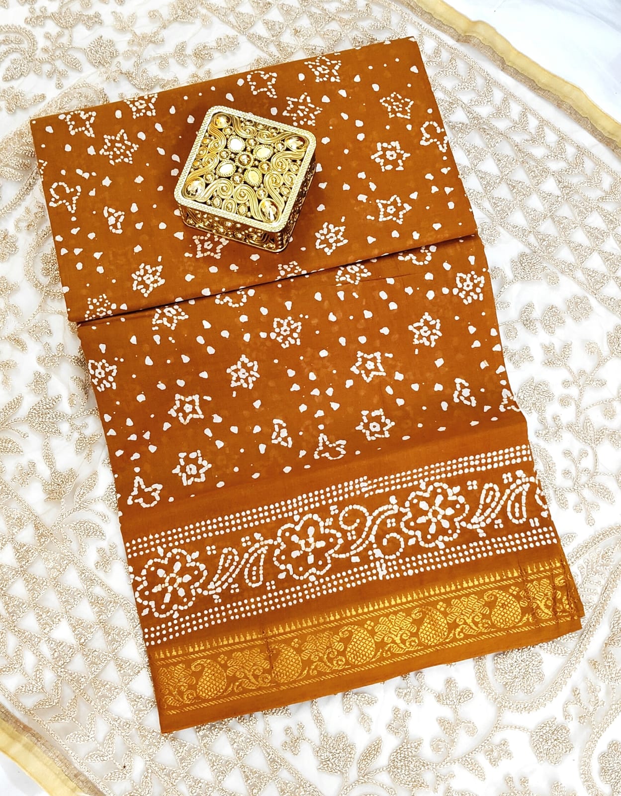 "Earthy Elegance β Rust brown Bandhani Saree with Floral Zari Border"